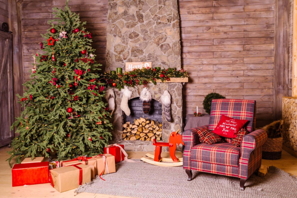 Cozy Christmas Living Room with Tree, Fireplace & Festive Decor Wallpaper