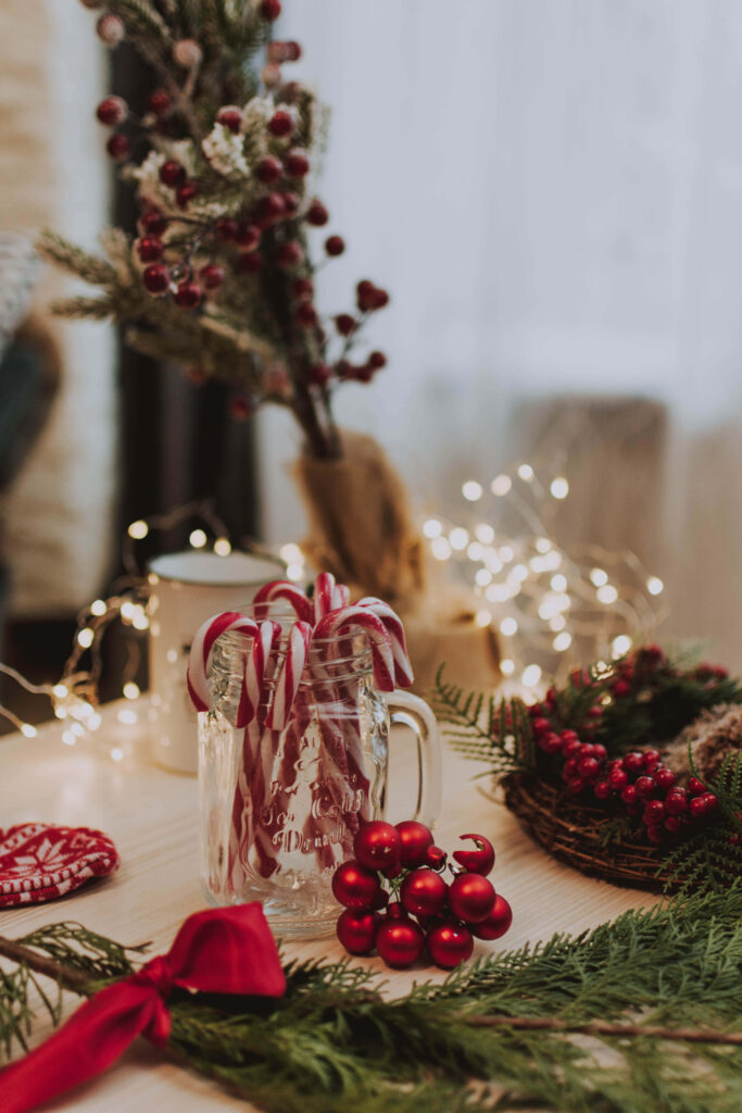 Festive Christmas Table with Candy Canes & Warm Fairy Lights Wallpaper