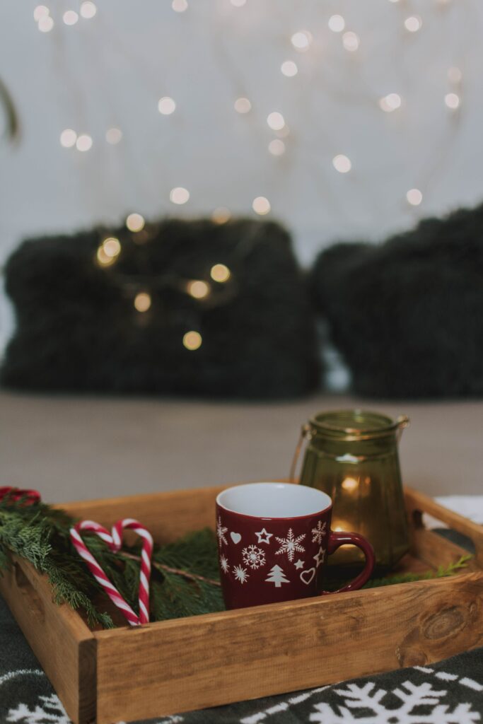 Cozy Holiday Scene: Festive Tray with Red Mug & Candy Canes Wallpaper
