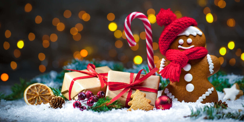 Cozy Christmas Wallpaper: Gingerbread Scene with Snowy Evergreens