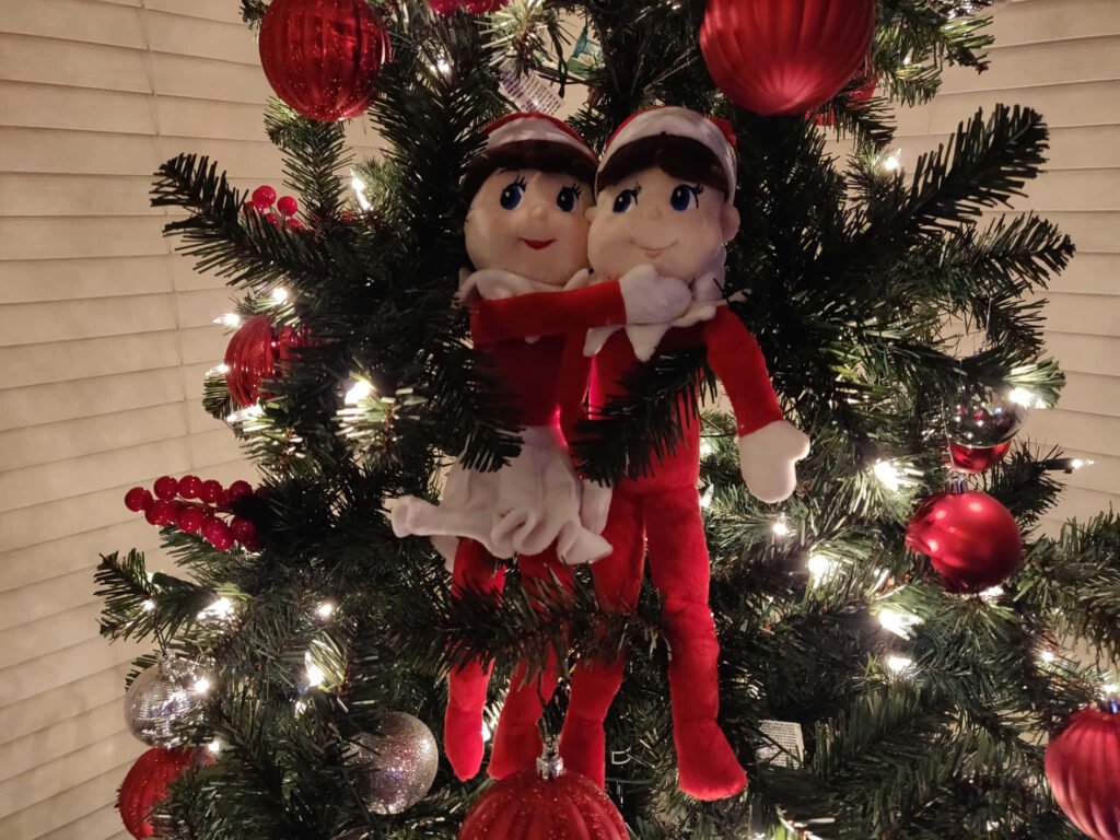 Cozy Christmas Wallpaper: Cute Elf Dolls in Twinkling Tree Scene