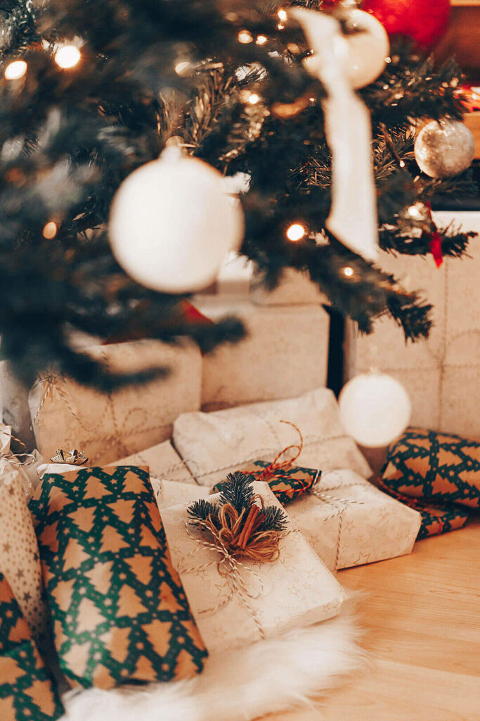 Cozy Christmas Scene: Wrapped Presents Under a Decorated Tree Wallpaper