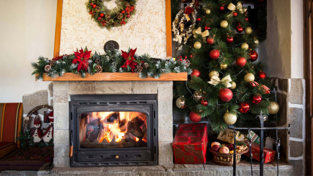 Cozy Christmas Scene: Decorated Fireplace & Tree Background Wallpaper