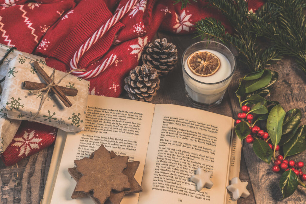 Cozy Christmas Flat Lay: Book, Cookies, and Warm Holiday Decor Wallpaper