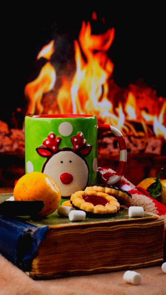Cozy Christmas Wallpaper: Festive Fire & Reindeer Mug Delight