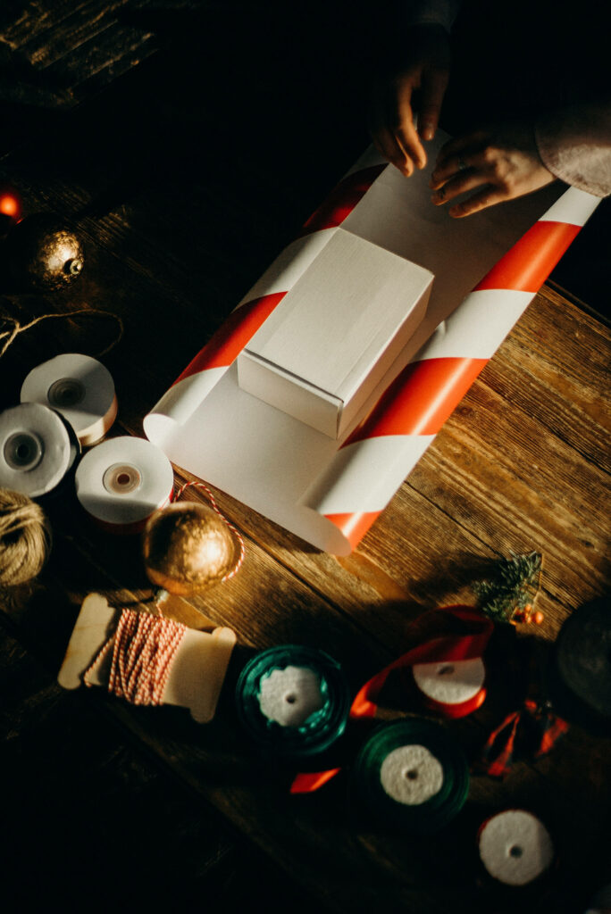 Festive Christmas Wallpaper: Cozy Gift Wrapping Scene Background