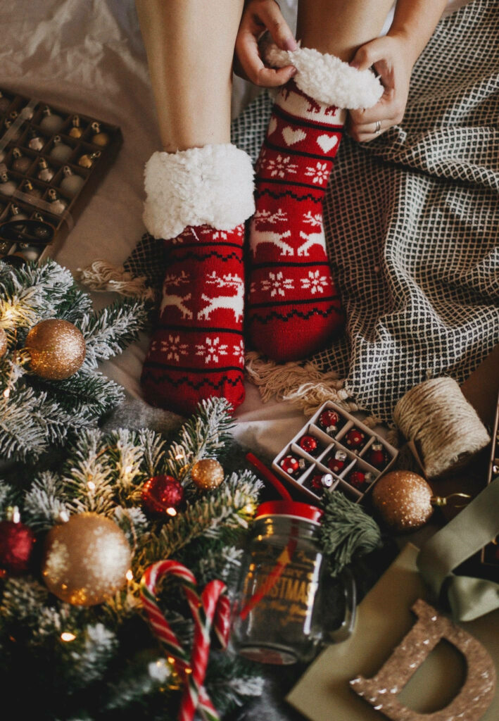 Cozy Christmas Wallpaper: Red Holiday Socks & Decorated Tree