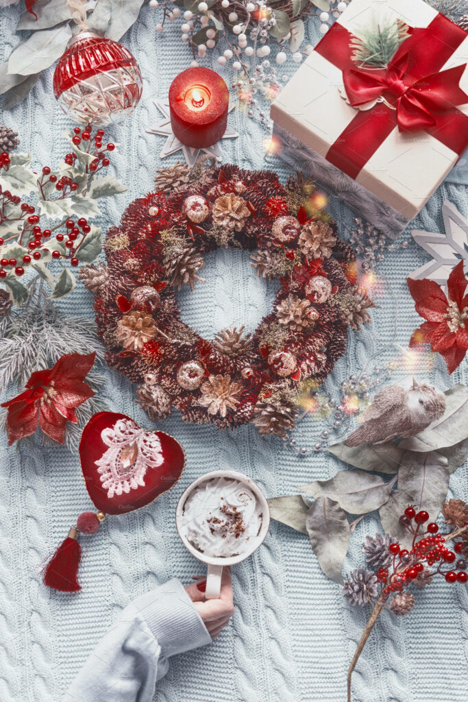 Cozy Christmas Aesthetic: Red Wreath, Cocoa, and Knitted Background Wallpaper