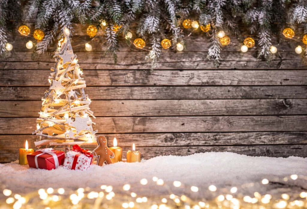 Charming Christmas Scene: Rustic Backdrop with Sparkling Tree & Gifts Wallpaper