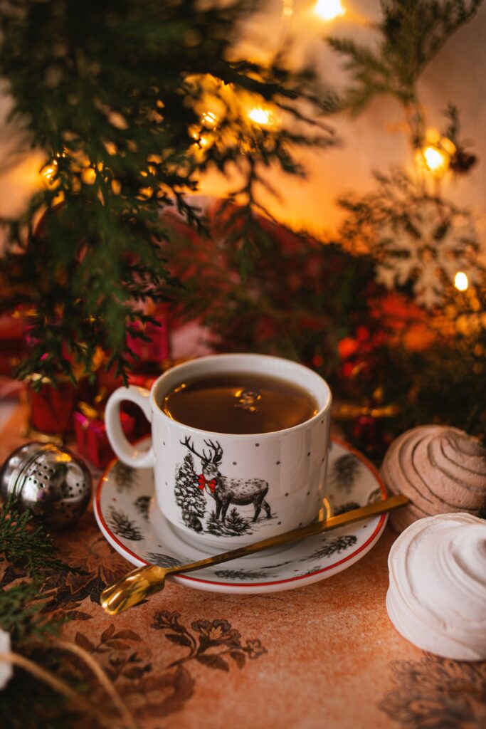 Cozy Holiday Wallpaper: Festive Tea Scene with Ornaments & Lights