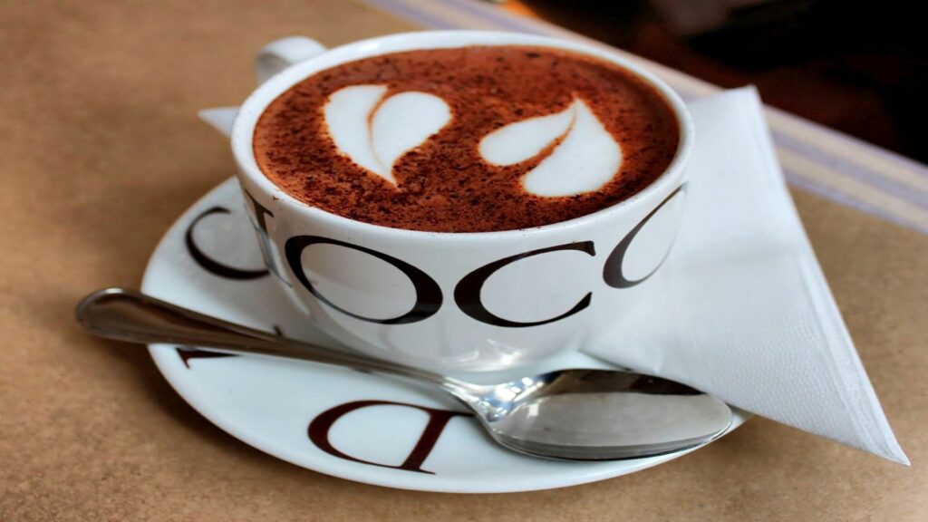 Heart-Shaped Latte Art: Cozy Coffee Cup Wallpaper for Warm Ambiance