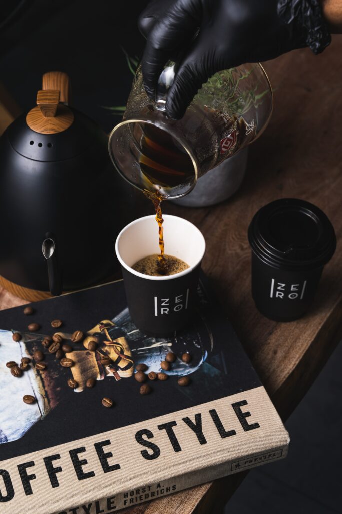 Cozy Coffee Setup: Freshly Brewed Pour with Stylish Accessories Wallpaper