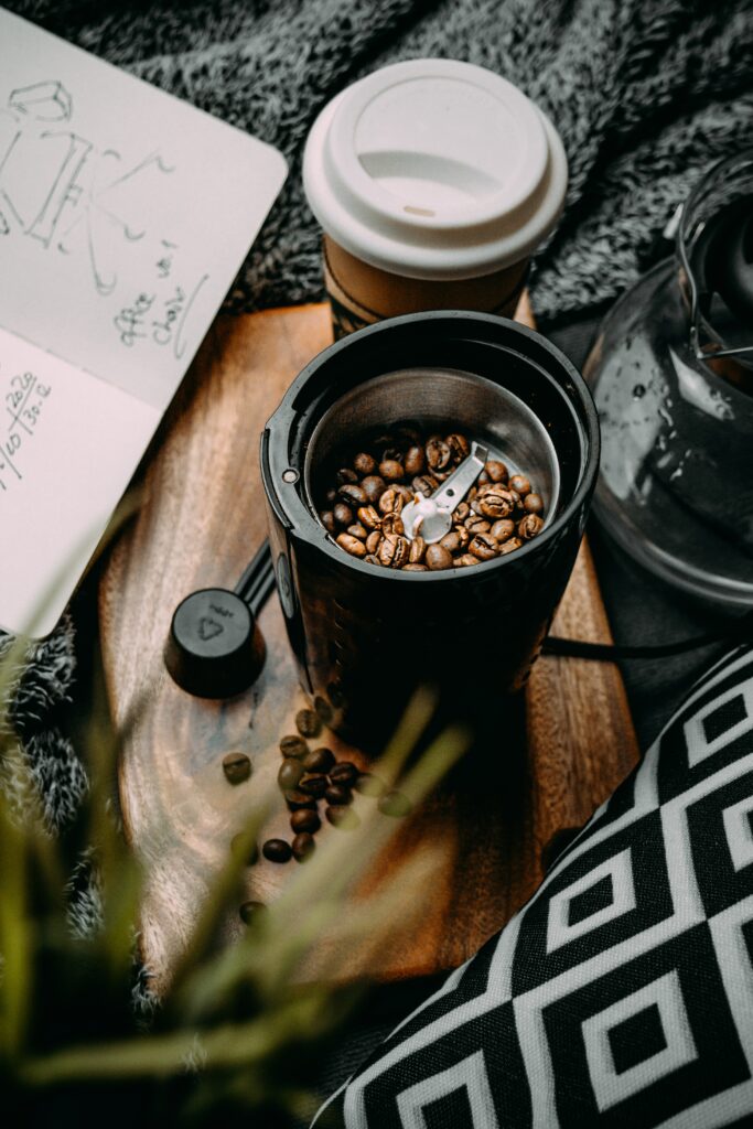 Cozy Coffee Setup: Grinder, Cup & Notebook on Wooden Tray Wallpaper