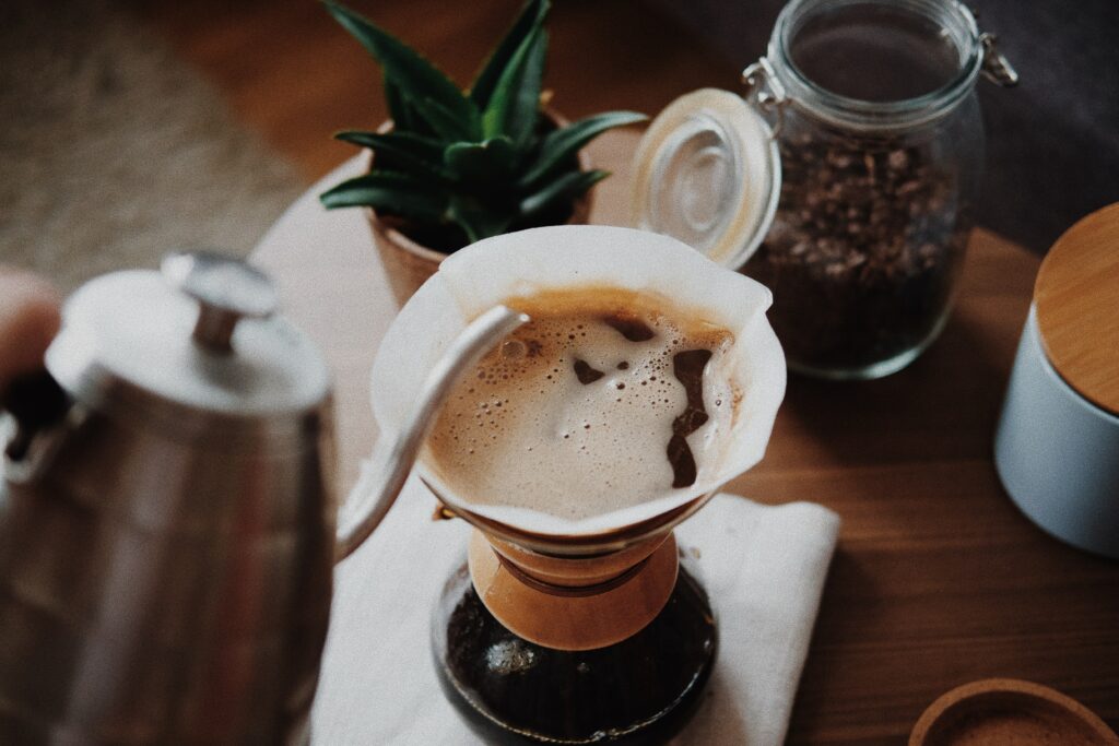 Cozy Coffee Wallpaper: Pour-Over Setup with Beans & Green Plant