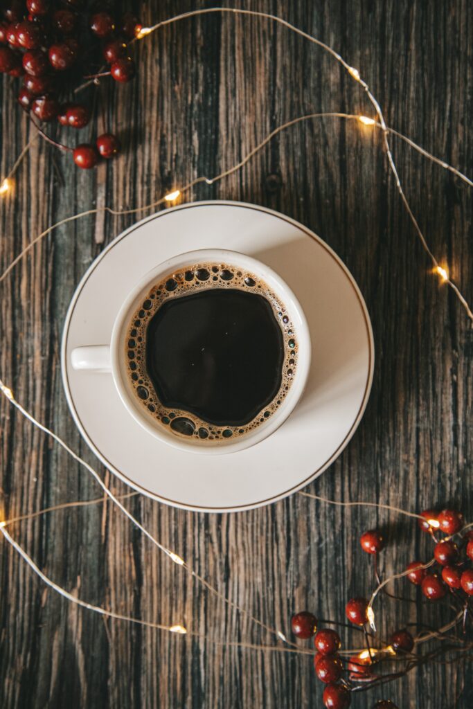 Warm Coffee Wallpaper: Rustic Charm with Garland Lights & Berries