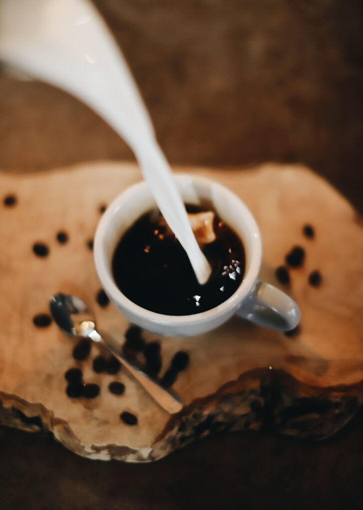 Cozy Wallpaper: Steaming Coffee Cup with Milk & Rustic Beans