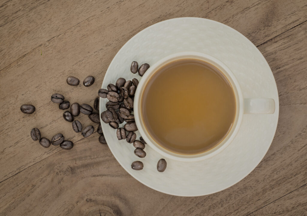 Cozy Coffee Wallpaper: Warm Cup on Textured Plate with Beans