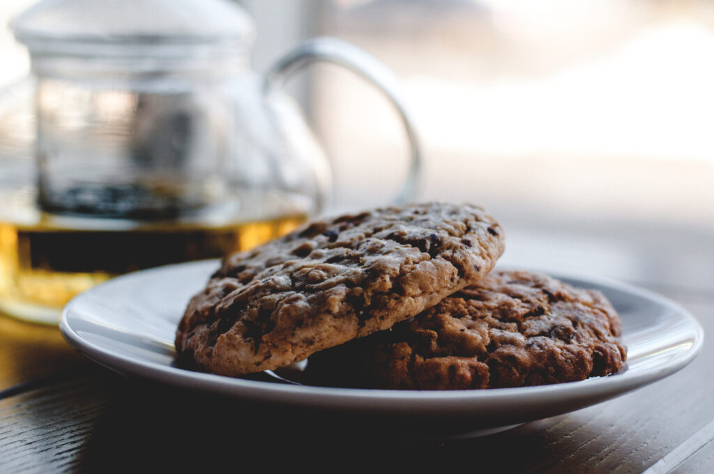 Cozy Cookies on White Plate with Teapot - Inviting Wallpaper Background