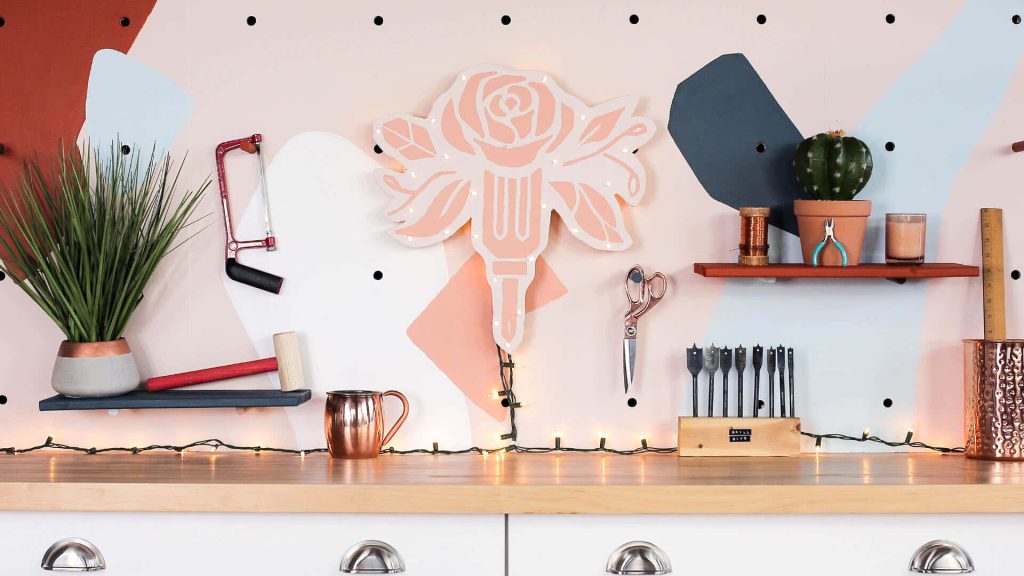 Cozy creative studio Zoom background with pink pegboard, fairy lights, wooden shelf, and tools Wallpaper