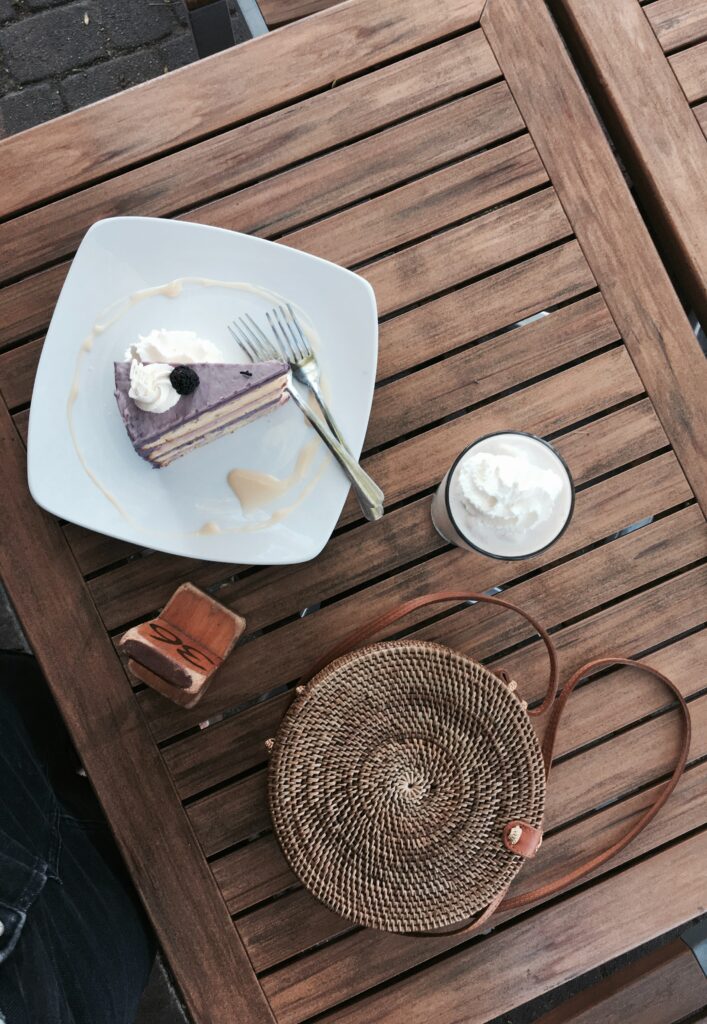 Cozy Dessert Setting: Layered Cake & Creamy Latte on Rustic Table Wallpaper