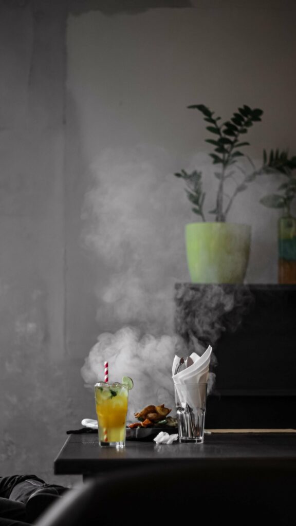 Cozy Dining: Steaming Dish & Refreshing Orange Drink on Minimalist Table Wallpaper