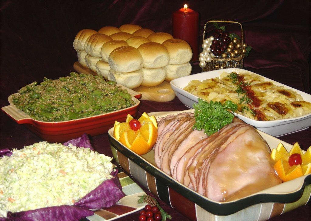 Cozy Dinner Setting: Glazed Ham, Pasta & More with Fruit Accents Wallpaper