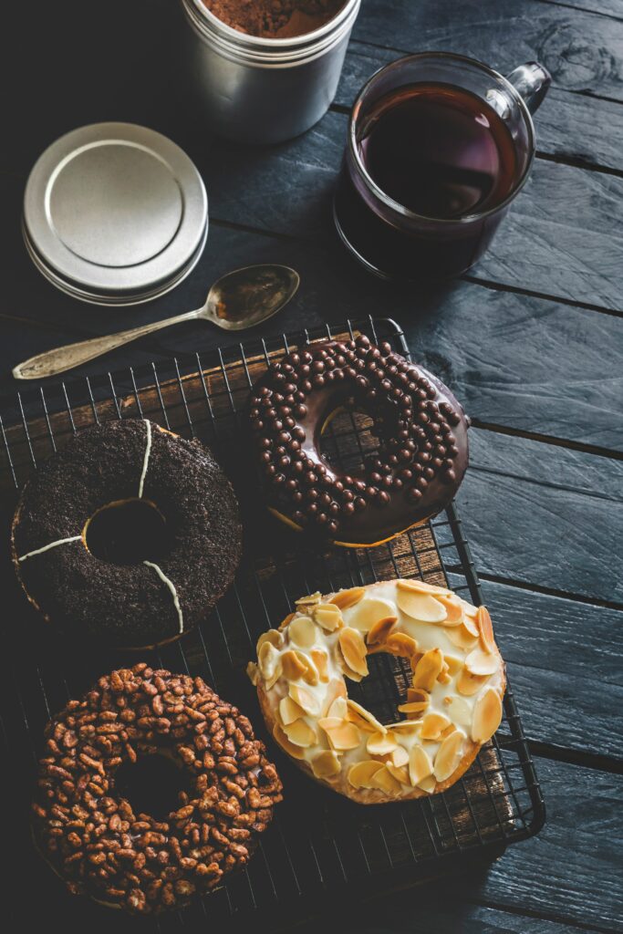 Cozy Donut Assortment with Tea - Inviting Wallpaper Background