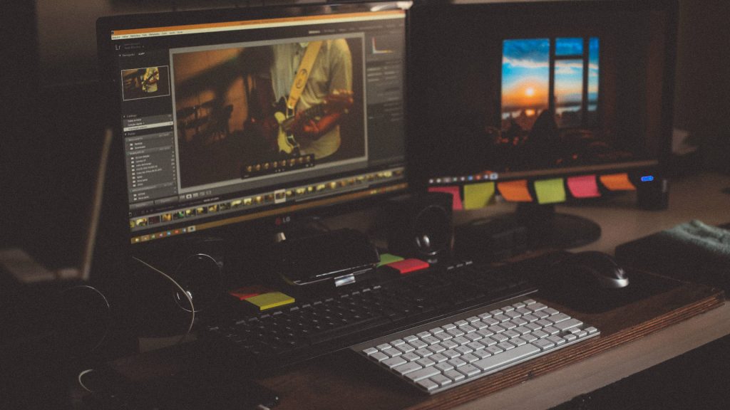 Full HD dual monitor wallpaper with cozy photo editing setup and sunset background ambiance