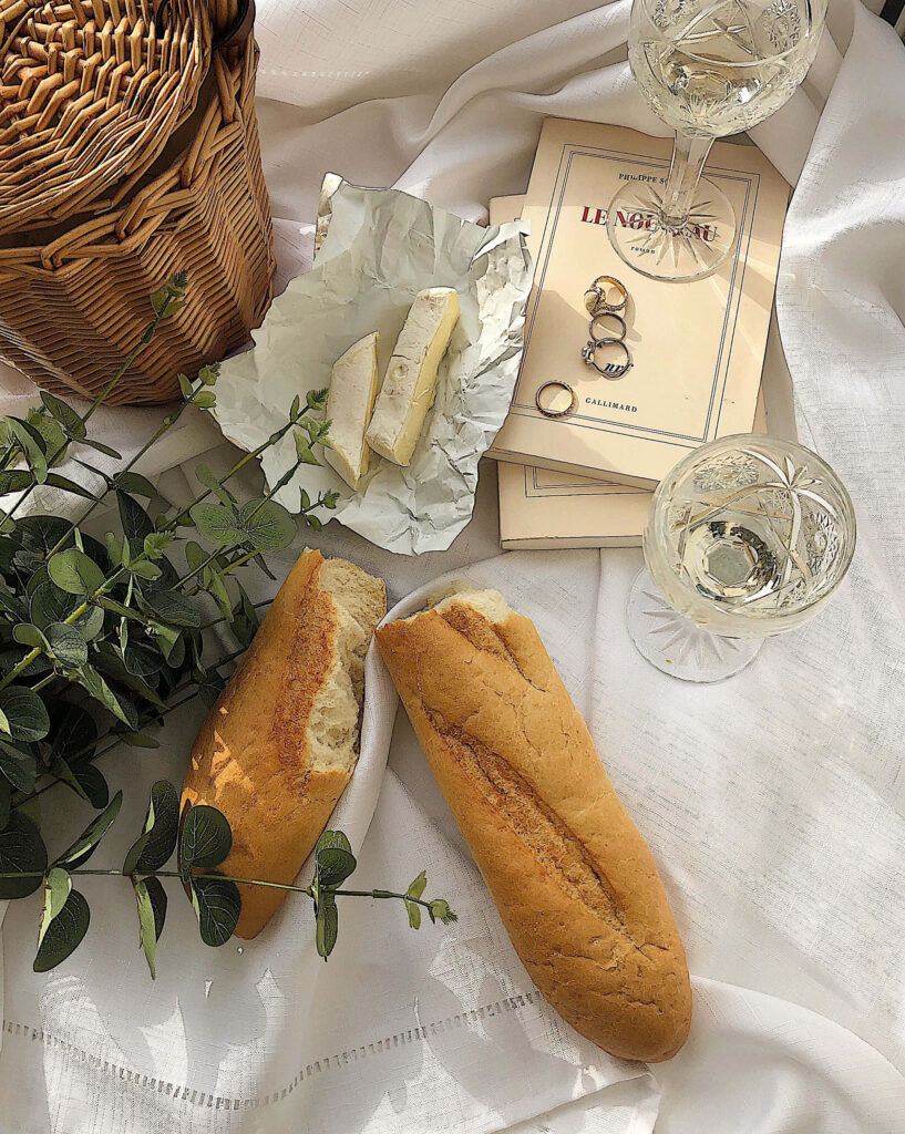 Cozy Rustic Dining: Fresh Baguettes, Cheese & Wine Wallpaper