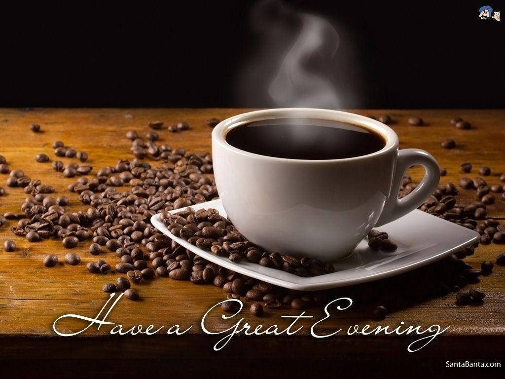 Steaming cup of black coffee on rustic table with roasted beans and evening greeting wallpaper