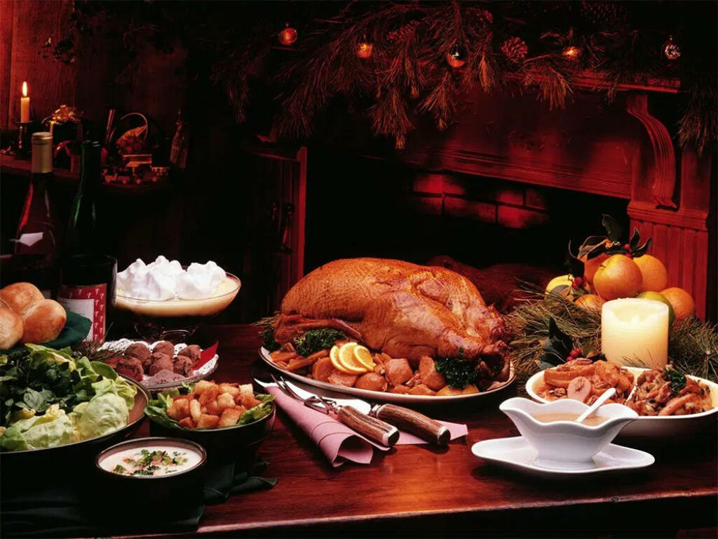 Festive Dining Setup with Roasted Turkey & Fresh Side Dishes Wallpaper