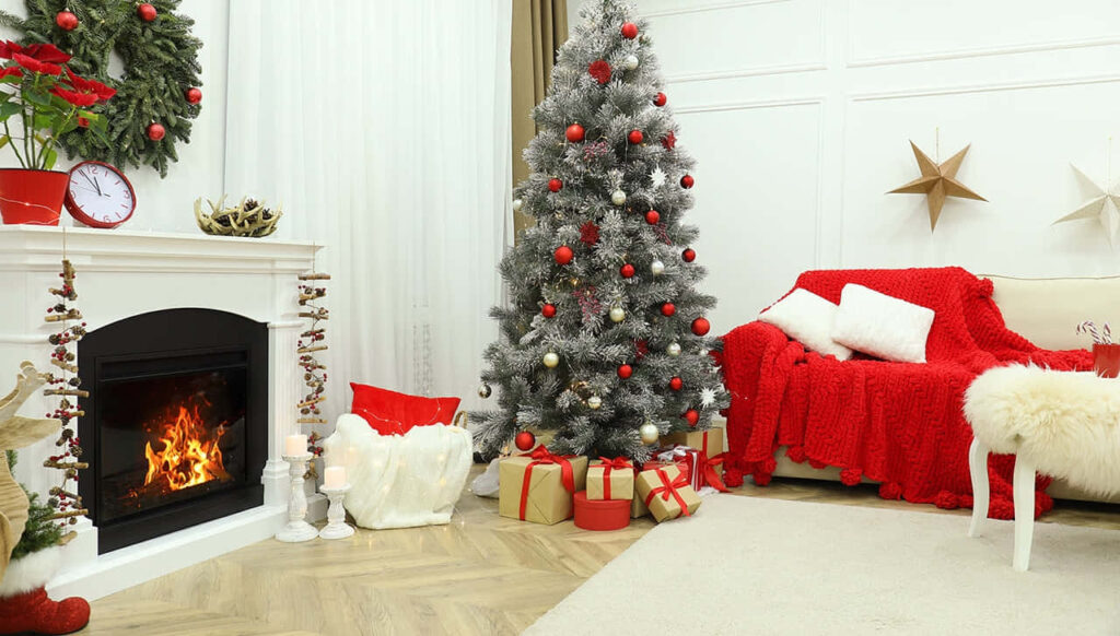 Festive Cozy Living Room with Christmas Tree & Warm Fire Wallpaper