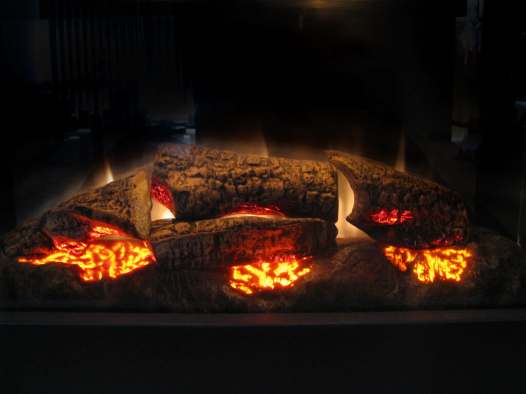 Cozy fireplace with glowing logs radiating warmth and comfort for relaxing atmosphere wallpaper