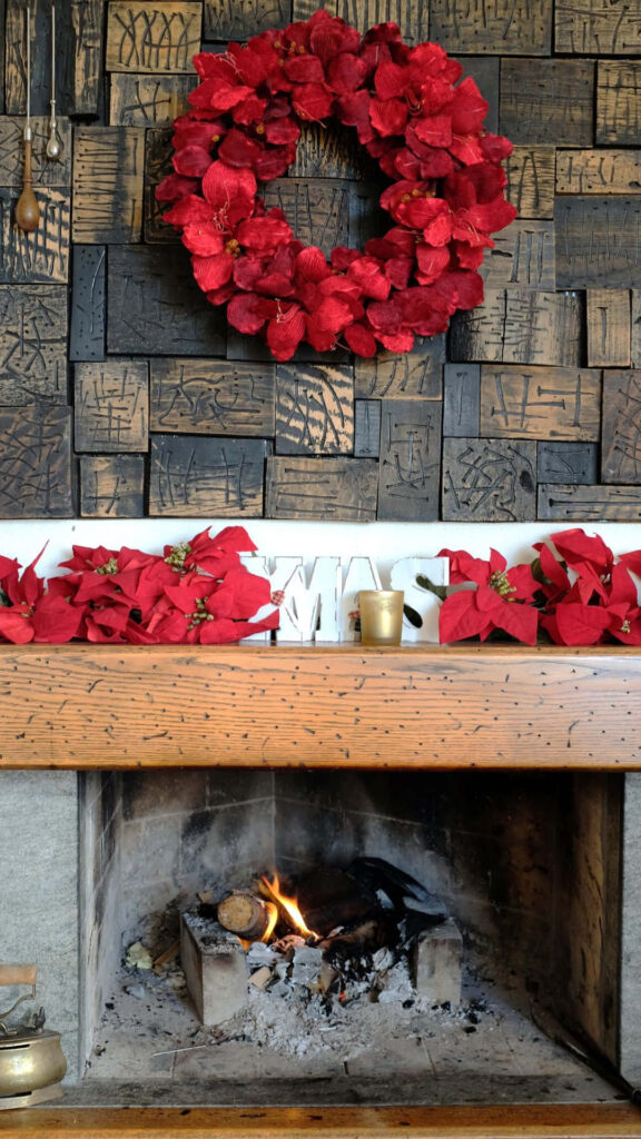 Cozy Fireplace with Vibrant Red Christmas Wreath - Holiday Background Wallpaper