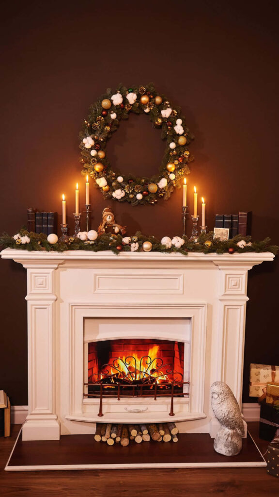 Festive Fireplace Decor: Cozy Christmas Ambiance with Candles & Garlands Wallpaper