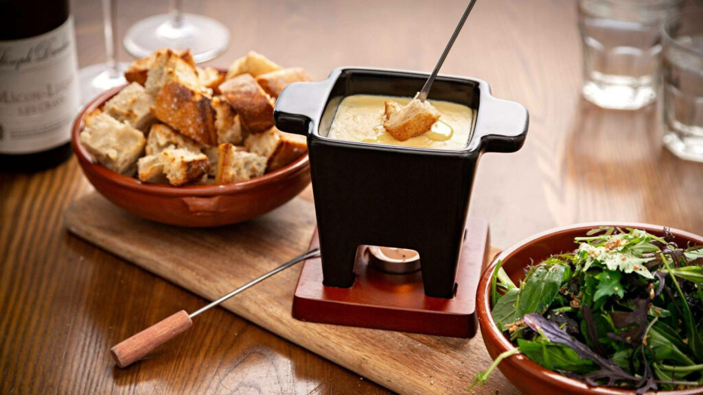 Cozy Fondue Pot Wallpaper: Melted Cheese & Bread Cubes Delight