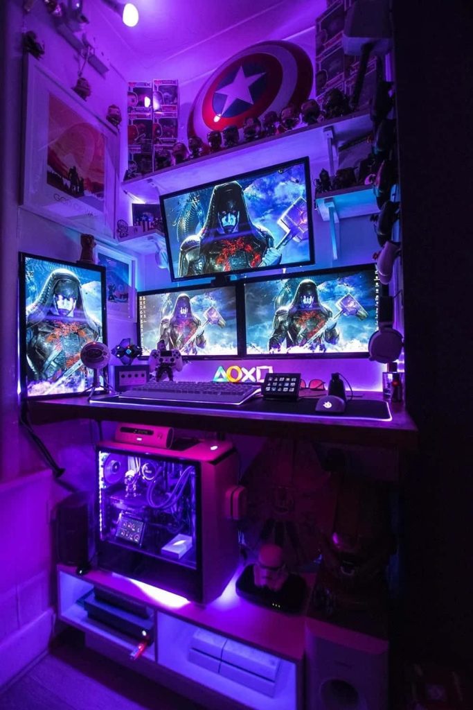 Futuristic gaming room with triple monitors Destiny 2 neon lights Captain America shield PC tower Wallpaper