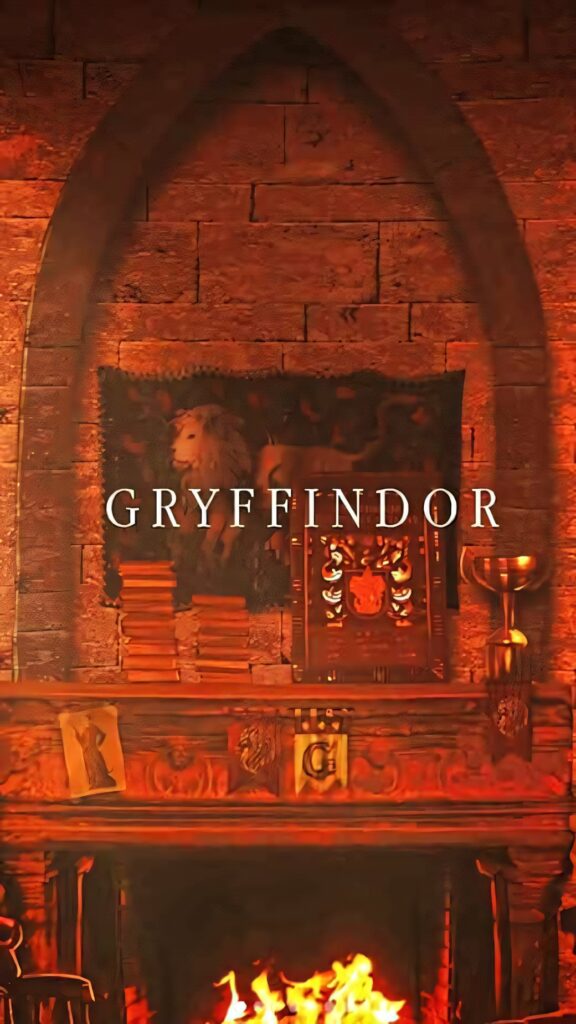 Warm Gryffindor common room fireplace with lion tapestry books and magical Harry Potter decor Wallpaper
