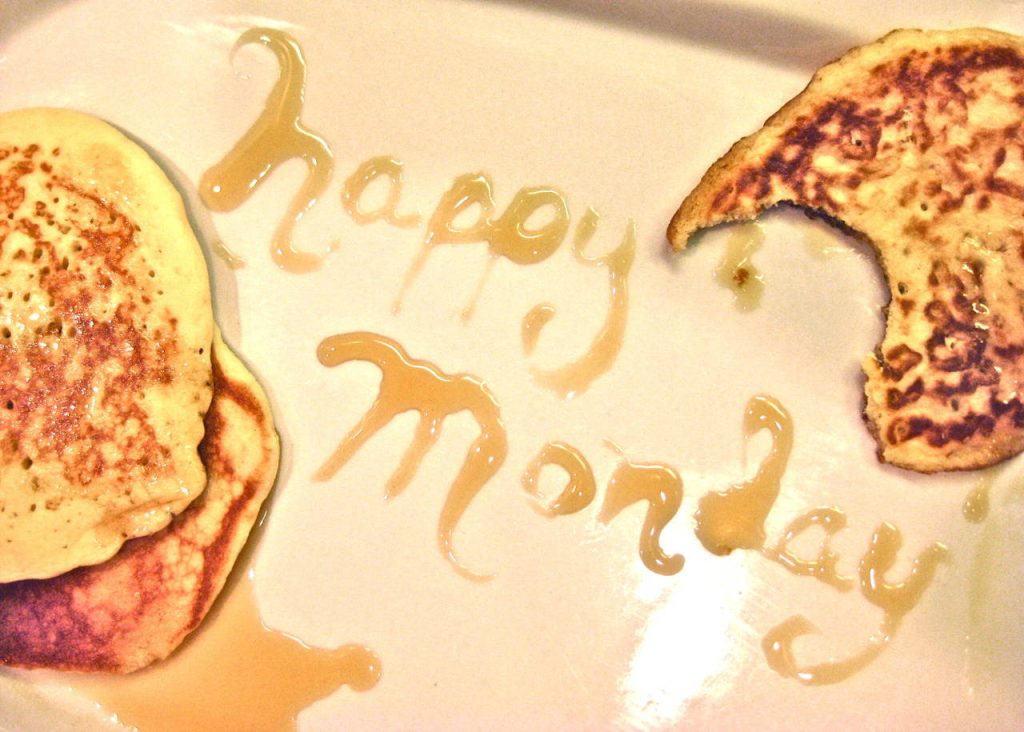 Cozy Happy Monday wallpaper with golden pancakes syrup script toast warm breakfast background
