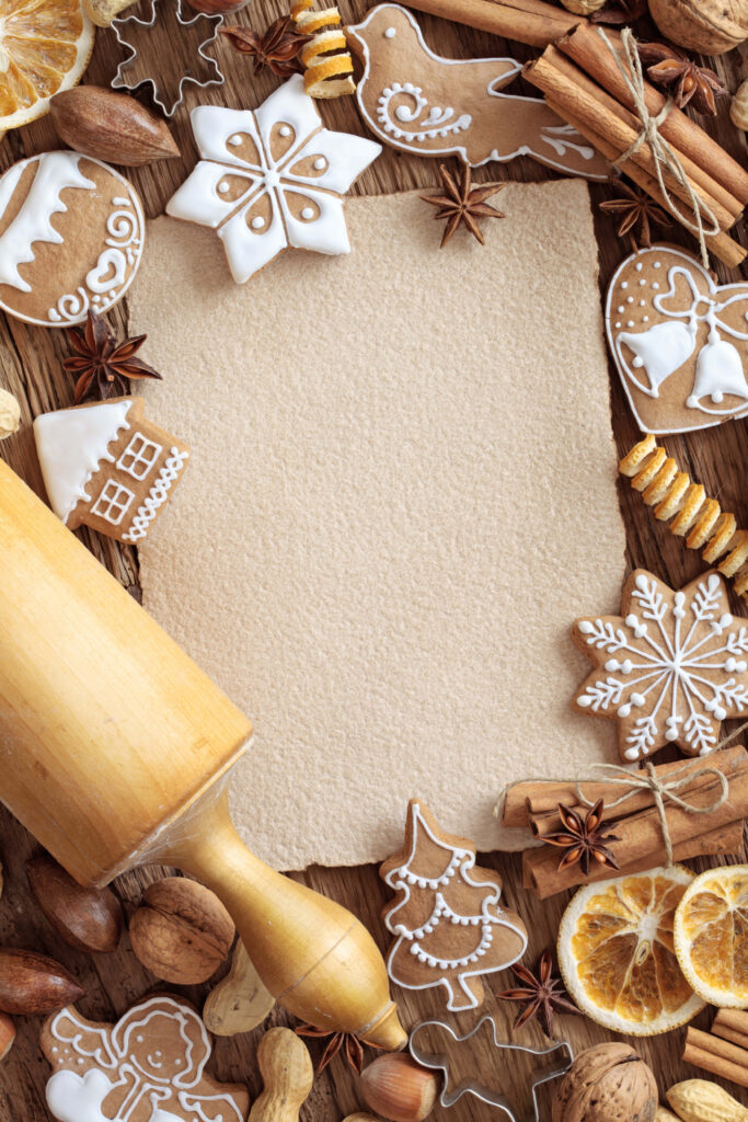 Festive gingerbread cookies with cinnamon dried orange and nuts on rustic wooden background Wallpaper