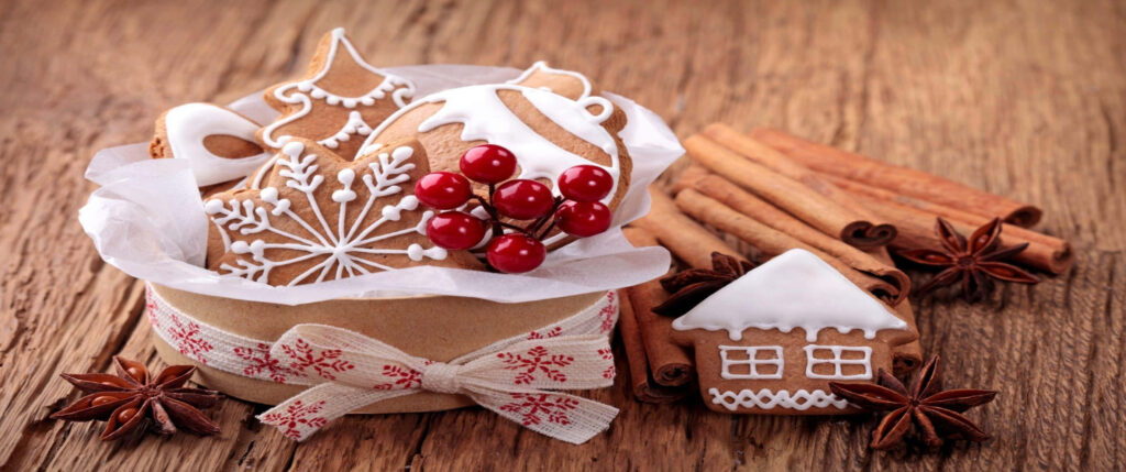 Cozy holiday wallpaper with gingerbread cookies cinnamon star anise red berries on wood