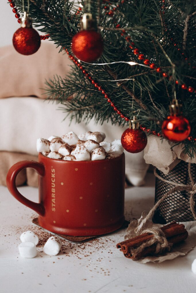 Cozy Holiday Wallpaper: Festive Mug & Decorated Christmas Tree