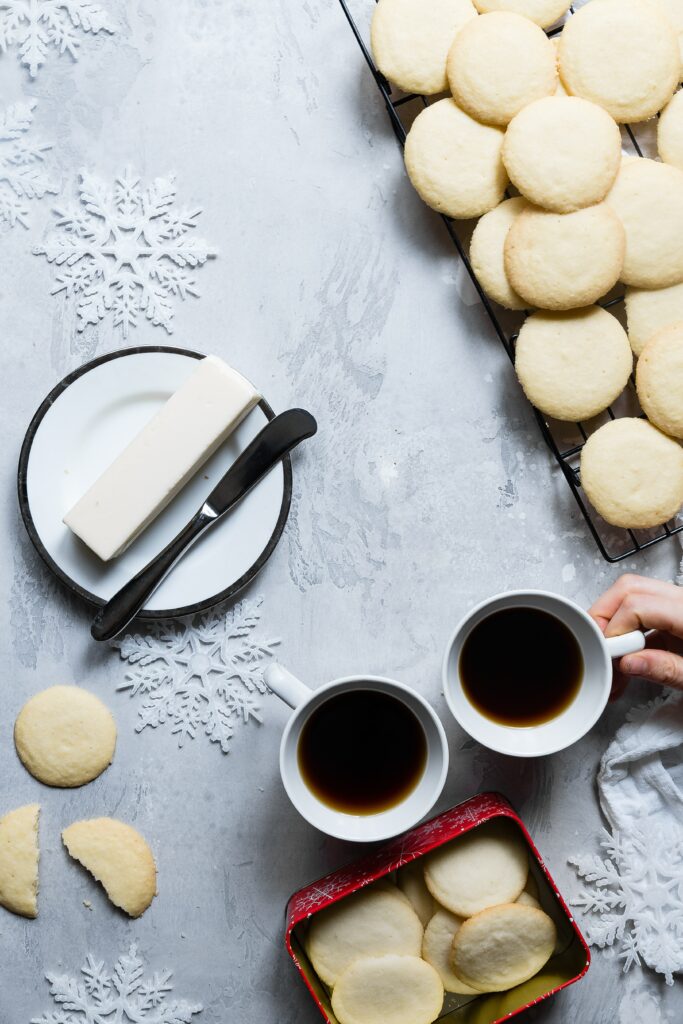 Cozy Biscuit Scene with Pastries & Coffee on Snowflake Wallpaper