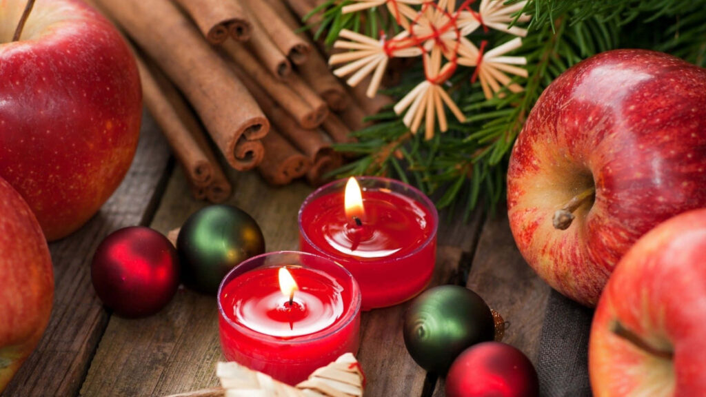 Cozy Christmas Wallpaper: Red Candles, Apples & Holiday Decor