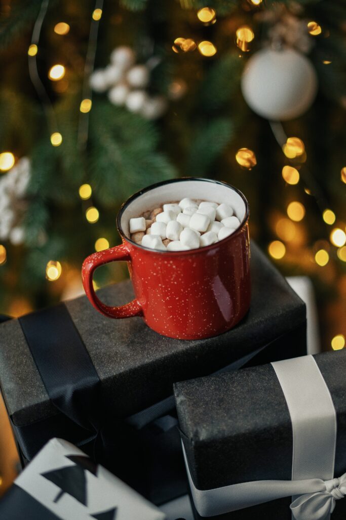Cozy Holiday Wallpaper: Red Mug with Marshmallows & Gift Boxes