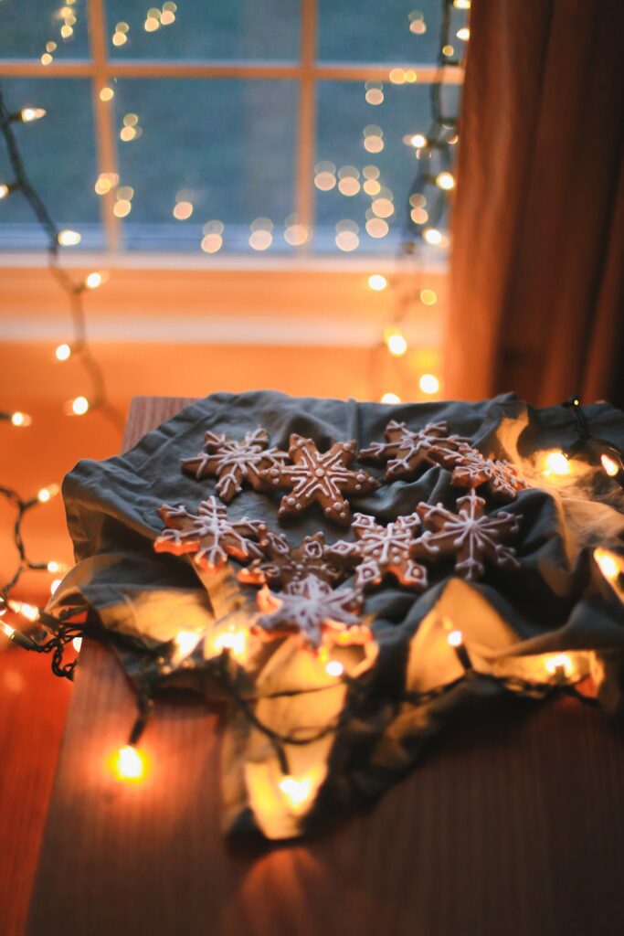 “Cozy Holiday Wallpaper: Festive Snowflake Cookies & Warm Lights”