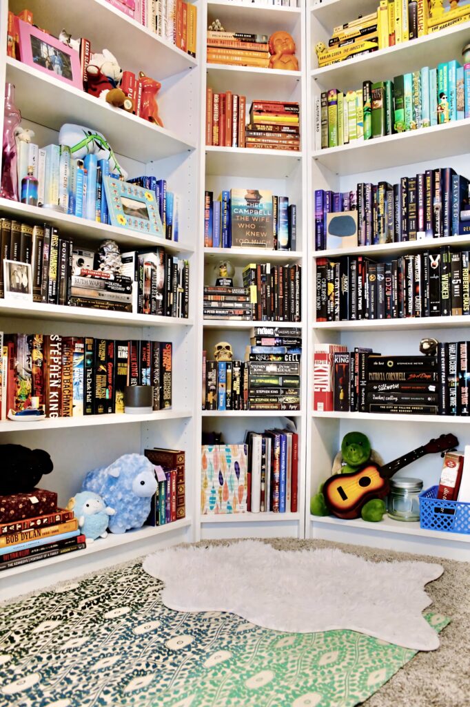Cozy home library with colorful books neatly arranged on shelves creating a warm reading space Wallpaper