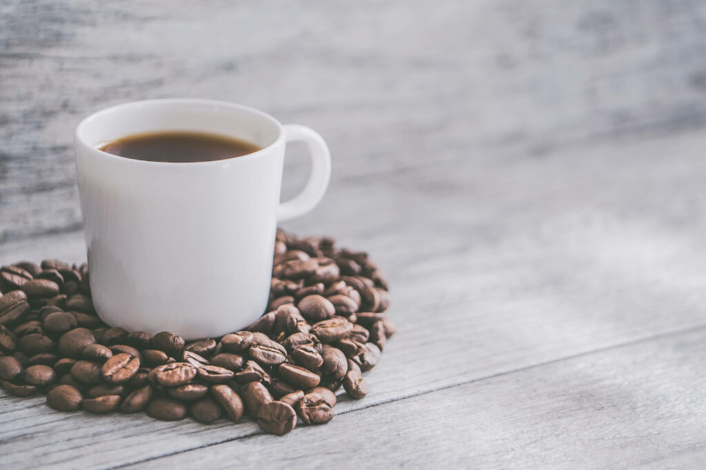 Cozy Hot Coffee Cup on Coffee Beans - Rustic Wallpaper Background
