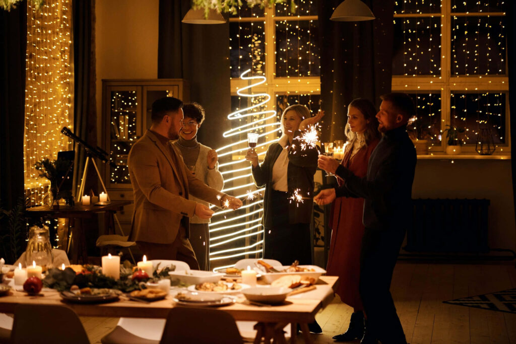 Cozy Indoor Celebration: Sparklers, String Lights & Festive Decor Wallpaper