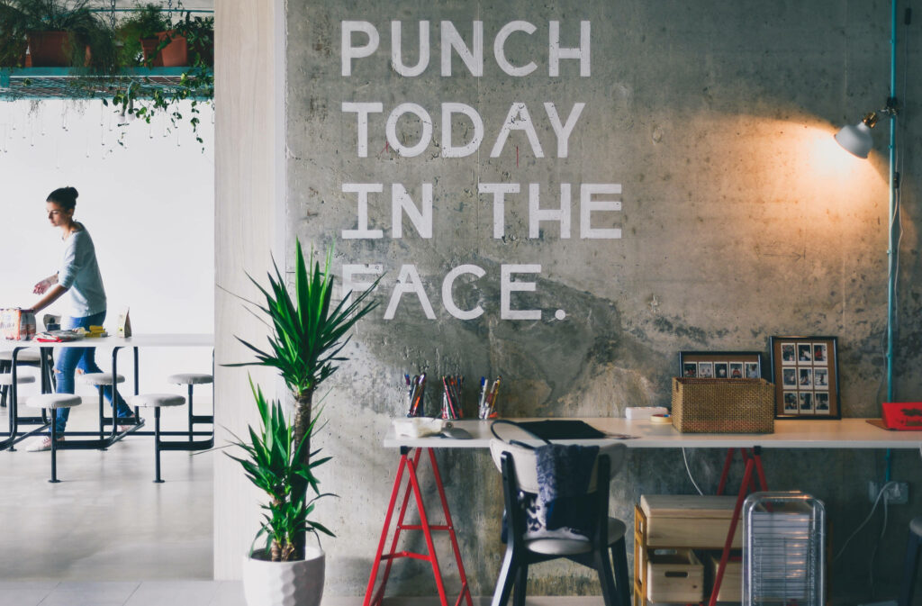 Cozy Workspace Wallpaper: Bold Quote & Natural Elements Design